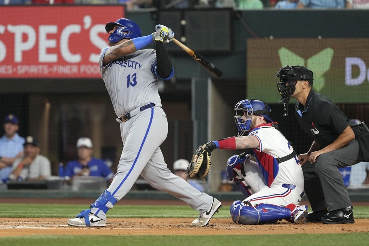 Jun 17, 2025; Arlington, Texas, USA; Kansas City Royals catcher Salvador Perez (13) follows through on his two-run home run against the Texas Rangers during the first inning at Globe Life Field. Mandatory Credit: Jim Cowsert-Imagn Images