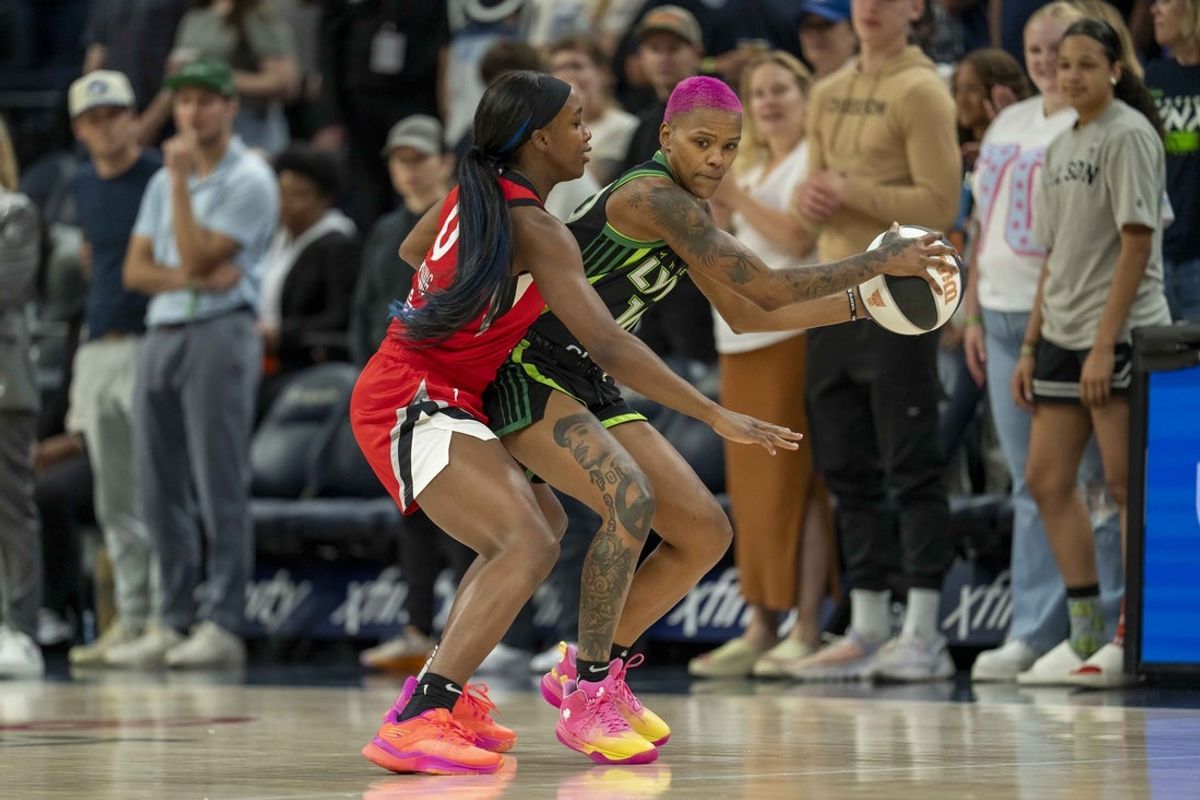 Jun 17, 2025; Minneapolis, Minnesota, USA; Minnesota Lynx guard Courtney Williams (10) holds the ball as Las Vegas Aces guard Jackie Young (0) plays defense in the first half at Target Center. Mandatory Credit: Jesse Johnson-Imagn Images