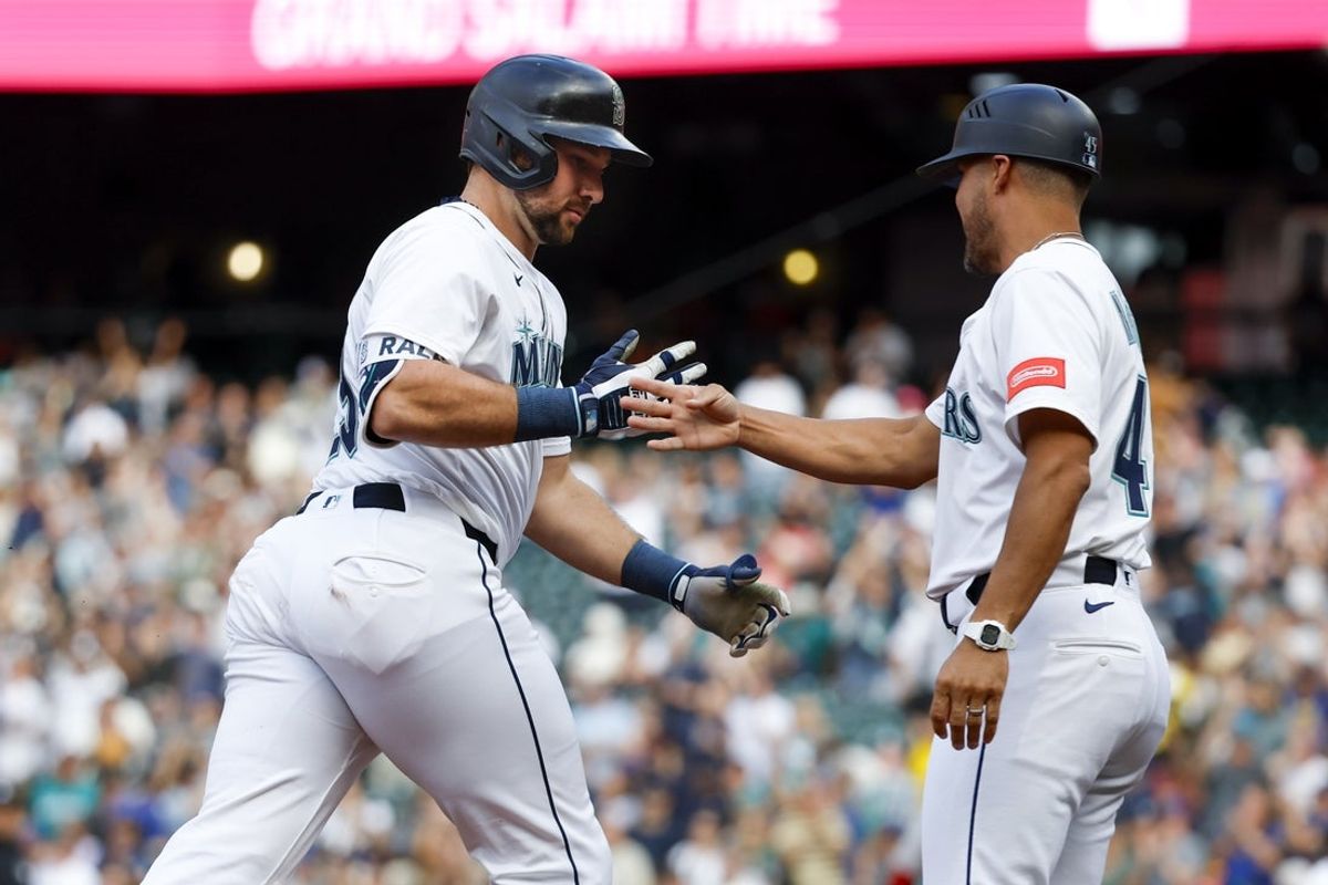 Jun 17, 2025; Seattle, Washington, USA; Seattle Mariners catcher Cal Raleigh (29) celebrates with third base coach Kristopher Negron (45) while running the bases after hitting a grand-slam home run against the Boston Red Sox during the second inning at T-Mobile Park. Mandatory Credit: Joe Nicholson-Imagn Images
