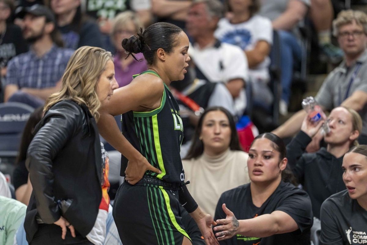 Jun 17, 2025; Minneapolis, Minnesota, USA; Minnesota Lynx forward Napheesa Collier (24) holds her lower back after exiting the game against the Las Vegas Aces in the second half at Target Center. Mandatory Credit: Jesse Johnson-Imagn Images