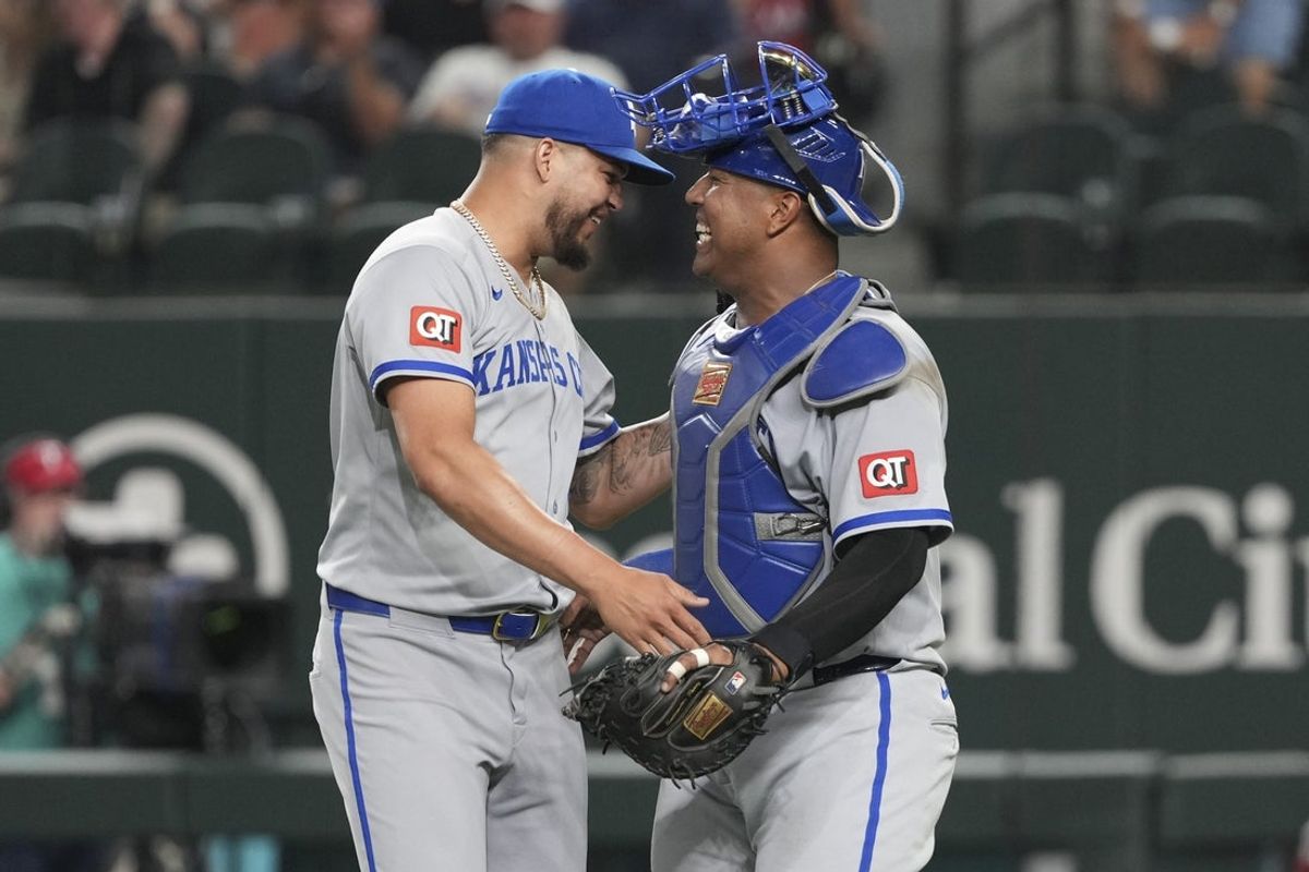 Jun 17, 2025; Arlington, Texas, USA; Kansas City Royals relief pitcher Steven Cruz (64) and catcher Salvador Perez (13) celebrate their teams 6-1 win over the Texas Rangers following the ninth inning at Globe Life Field. Mandatory Credit: Jim Cowsert-Imagn Images