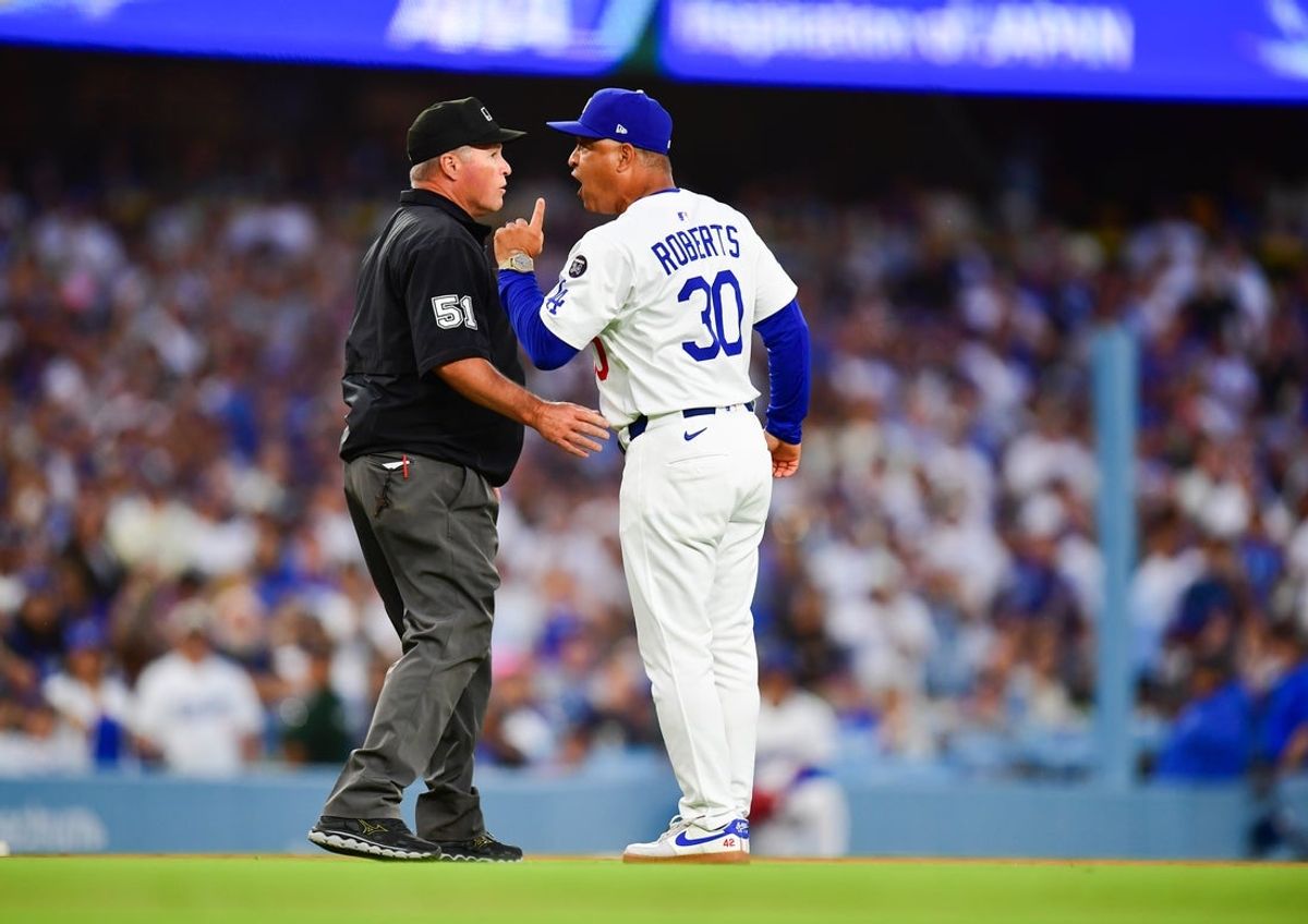 Jun 17, 2025; Los Angeles, California, USA; Los Angeles Dodgers manager Dave Roberts (30) argues with umpire Marvin Hudson (51) during the third inning against the San Diego Padres at Dodger Stadium. Mandatory Credit: Gary A. Vasquez-Imagn Images