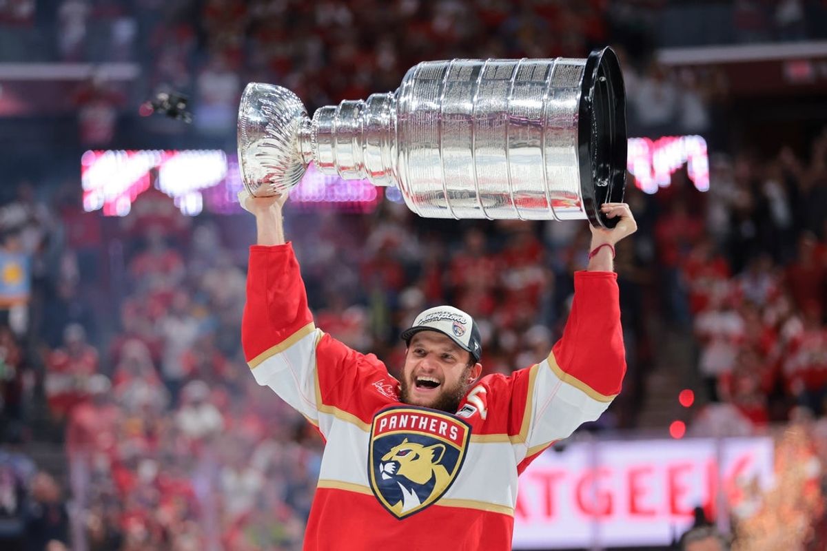 Jun 17, 2025; Sunrise, Florida, USA; Florida Panthers center Aleksander Barkov (16) hoists the Stanley Cup after winning game six of the 2025 Stanley Cup Final against the Edmonton Oilers at Amerant Bank Arena. Mandatory Credit: Sam Navarro-Imagn Images