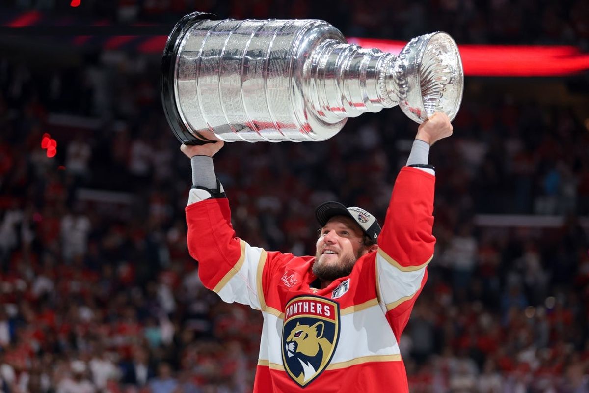 Jun 17, 2025; Sunrise, Florida, USA; Florida Panthers defenseman Dmitry Kulikov (7) hoists the Stanley Cup after winning game six of the 2025 Stanley Cup Final against the Edmonton Oilers at Amerant Bank Arena. Mandatory Credit: Sam Navarro-Imagn Images