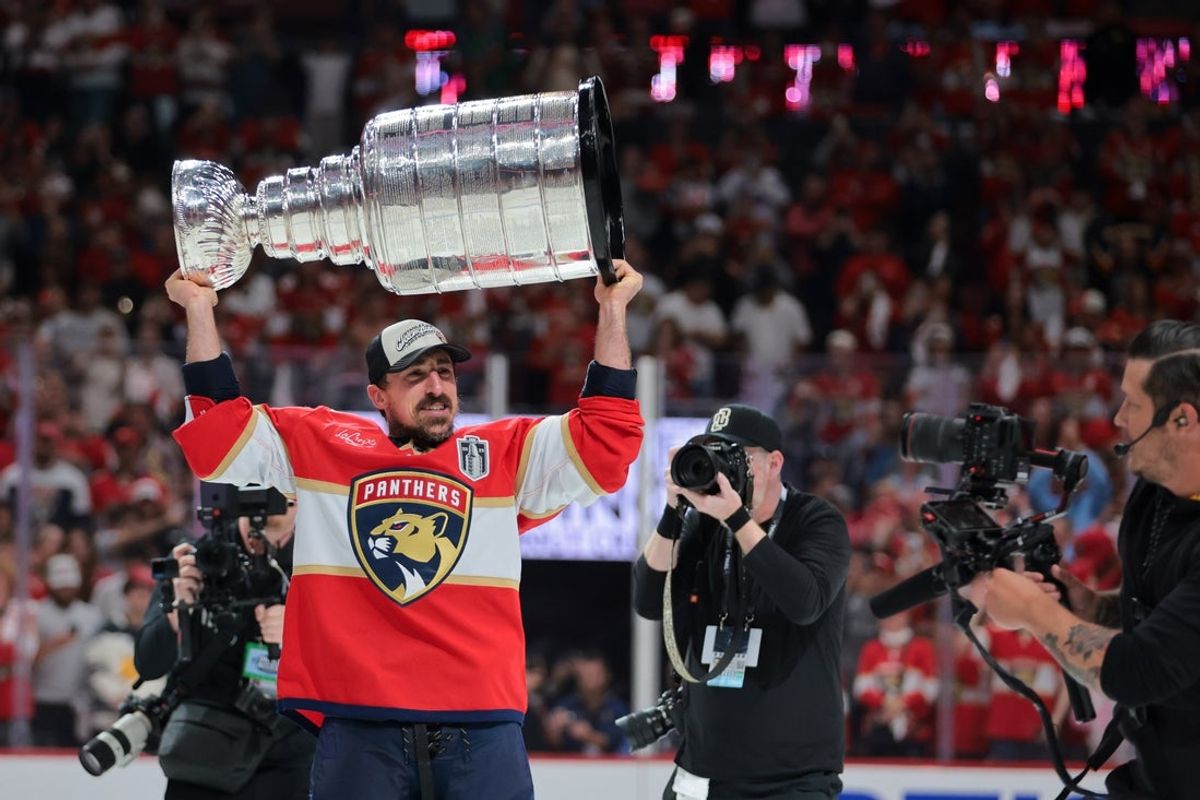 Jun 17, 2025; Sunrise, Florida, USA; Florida Panthers center Brad Marchand (63) hoists the Stanley Cup after winning game six of the 2025 Stanley Cup Final against the Edmonton Oilers at Amerant Bank Arena. Mandatory Credit: Sam Navarro-Imagn Images