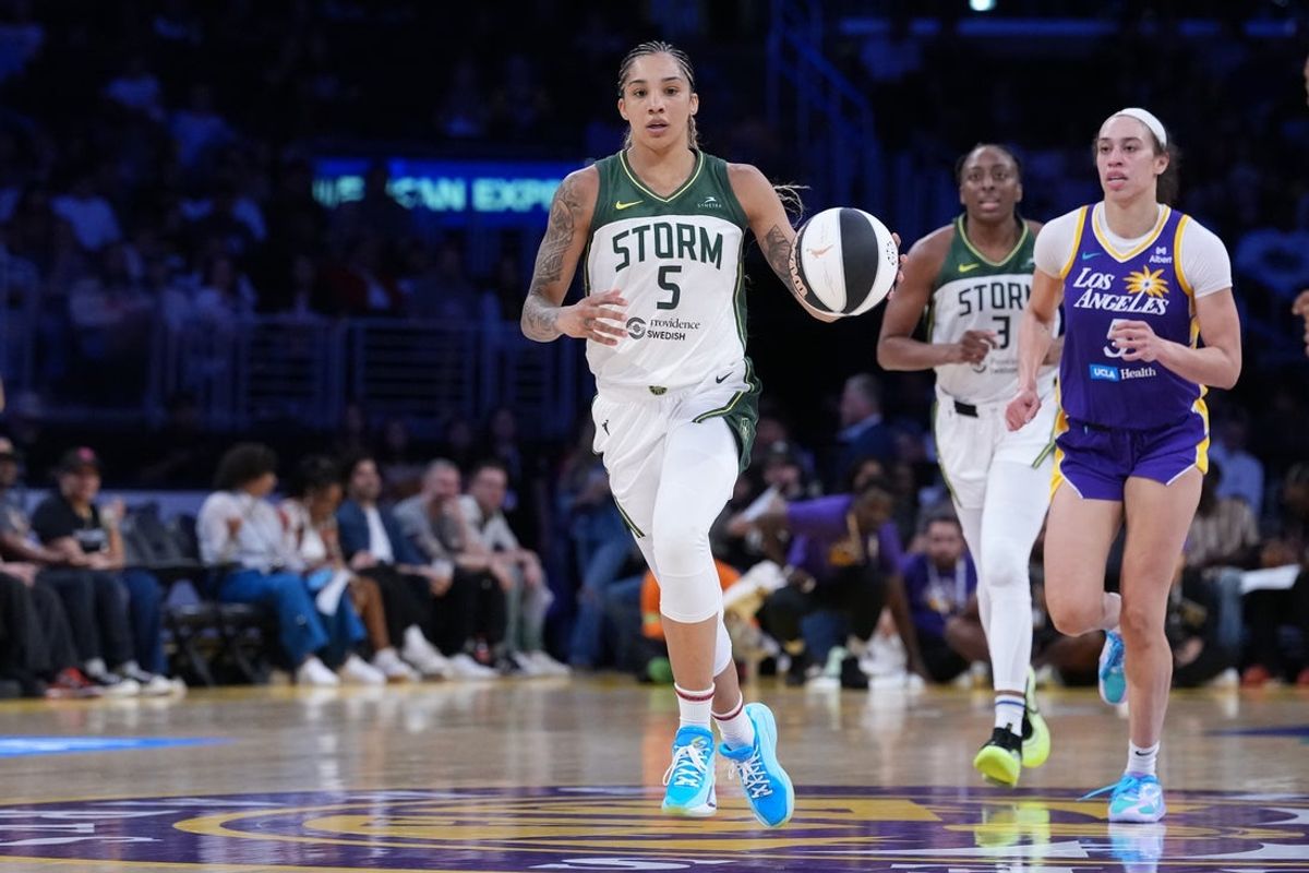 Jun 17, 2025; Los Angeles, California, USA; Seattle Storm forward Gabby Williams (5) dribbles the ball against LA Sparks forward Dearica Hamby (5) in the second half at Crypto.com Arena. Mandatory Credit: Kirby Lee-Imagn Images