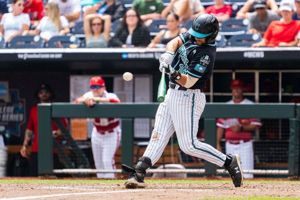 Jun 18, 2025; Omaha, Neb, USA; Coastal Carolina Chanticleers first baseman Colby Thorndyke (16) hits a single against the Louisville Cardinals during the fifth inning at Charles Schwab Field. Mandatory Credit: Dylan Widger-Imagn Images