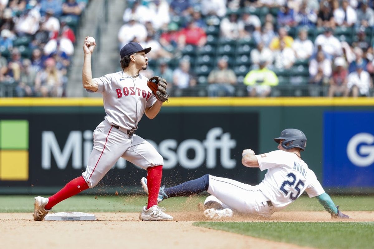 Jun 18, 2025; Seattle, Washington, USA; Boston Red Sox second baseman David Hamilton (17) throws to first after getting a forecourt of Seattle Mariners shortstop Dylan Moore (25) during the fifth inning at T-Mobile Park. Mandatory Credit: Joe Nicholson-Imagn Images