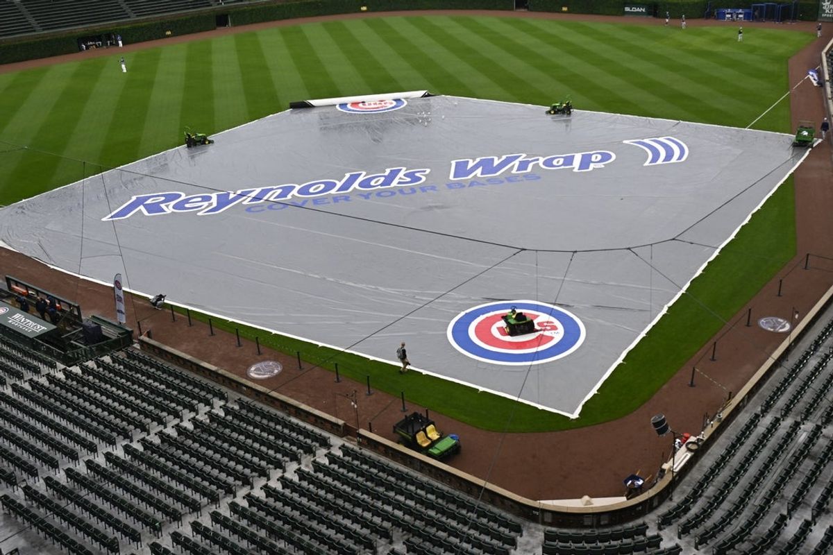 Jun 18, 2025; Chicago, Illinois, USA;  The tarp covers the field  before the weather cancelled game between the Chicago Cubs and the Milwaukee Brewers at Wrigley Field. Mandatory Credit: Matt Marton-Imagn Images
