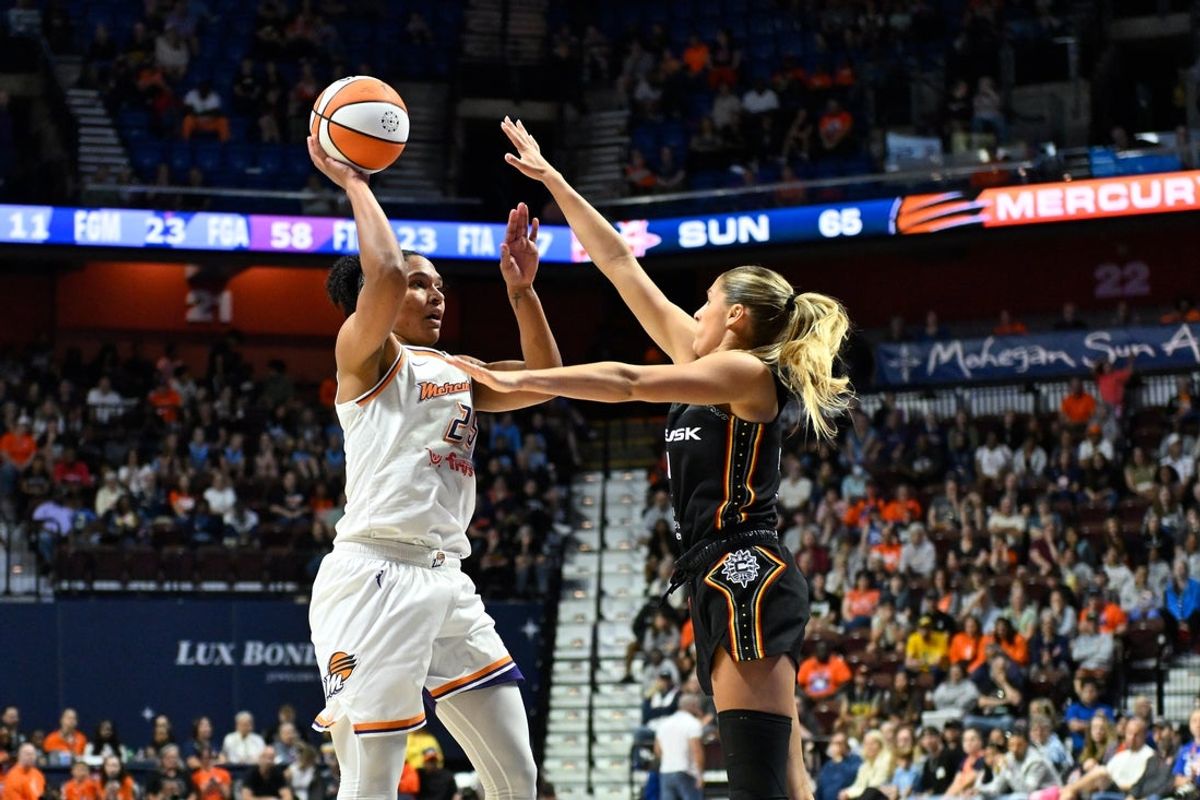 Jun 18, 2025; Uncasville, Connecticut, USA; Phoenix Mercury forward Alyssa Thomas (25) shoots the ball against the defense of Connecticut Sun guard Jacy Sheldon (4) during the second half at Mohegan Sun Arena. Mandatory Credit: Eric Canha-Imagn Images
