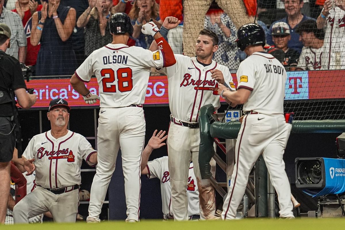 Jun 18, 2025; Cumberland, Georgia, USA; Atlanta Braves first baseman Matt Olson (28) reacts with third baseman Austin Riley (27) after hitting a home run against the New York Mets during the seventh inning at Truist Park. Mandatory Credit: Dale Zanine-Imagn Images
