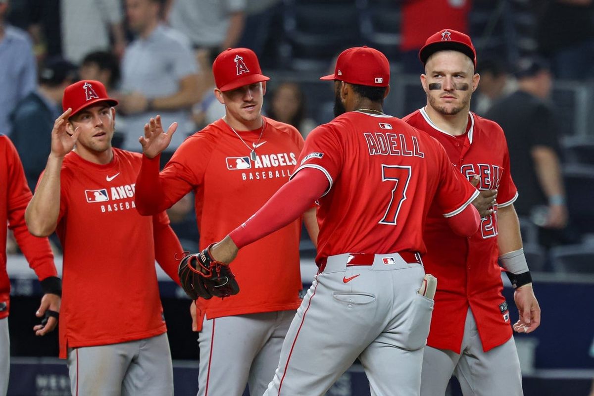 Jun 18, 2025; Bronx, New York, USA; Los Angeles Angels center fielder Jo Adell (7) and designated hitter Mike Trout (27) celebrate with teammates after defeating the New York Yankees at Yankee Stadium. Mandatory Credit: Vincent Carchietta-Imagn Images