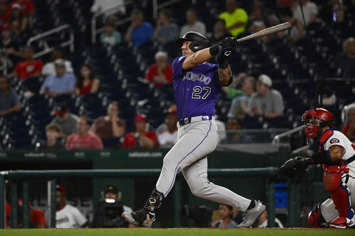 Jun 18, 2025; Washington, District of Columbia, USA; Colorado Rockies left fielder Jordan Beck (27) hits a solo home run against the Washington Nationals during the eighth inning at Nationals Park. Mandatory Credit: Brad Mills-Imagn Images