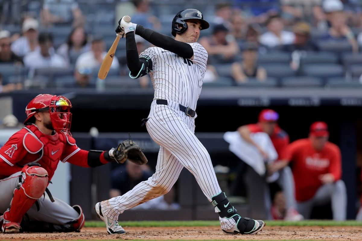 Jun 19, 2025; Bronx, New York, USA; New York Yankees left fielder Cody Bellinger (35) follows through on an RBI single against the Los Angeles Angels during the seventh inning at Yankee Stadium. Mandatory Credit: Brad Penner-Imagn Images