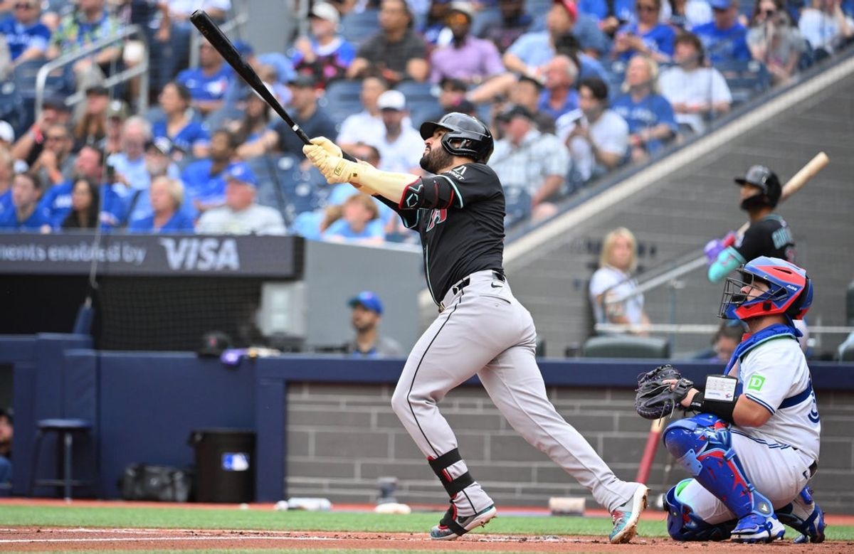 Jun 19, 2025; Toronto, Ontario, CAN;  Arizona Diamondbacks third baseman Eugenio Suarez (28) hits a two run home run against the Toronto Blue Jays in the second inning at Rogers Centre. Mandatory Credit: Dan Hamilton-Imagn Images