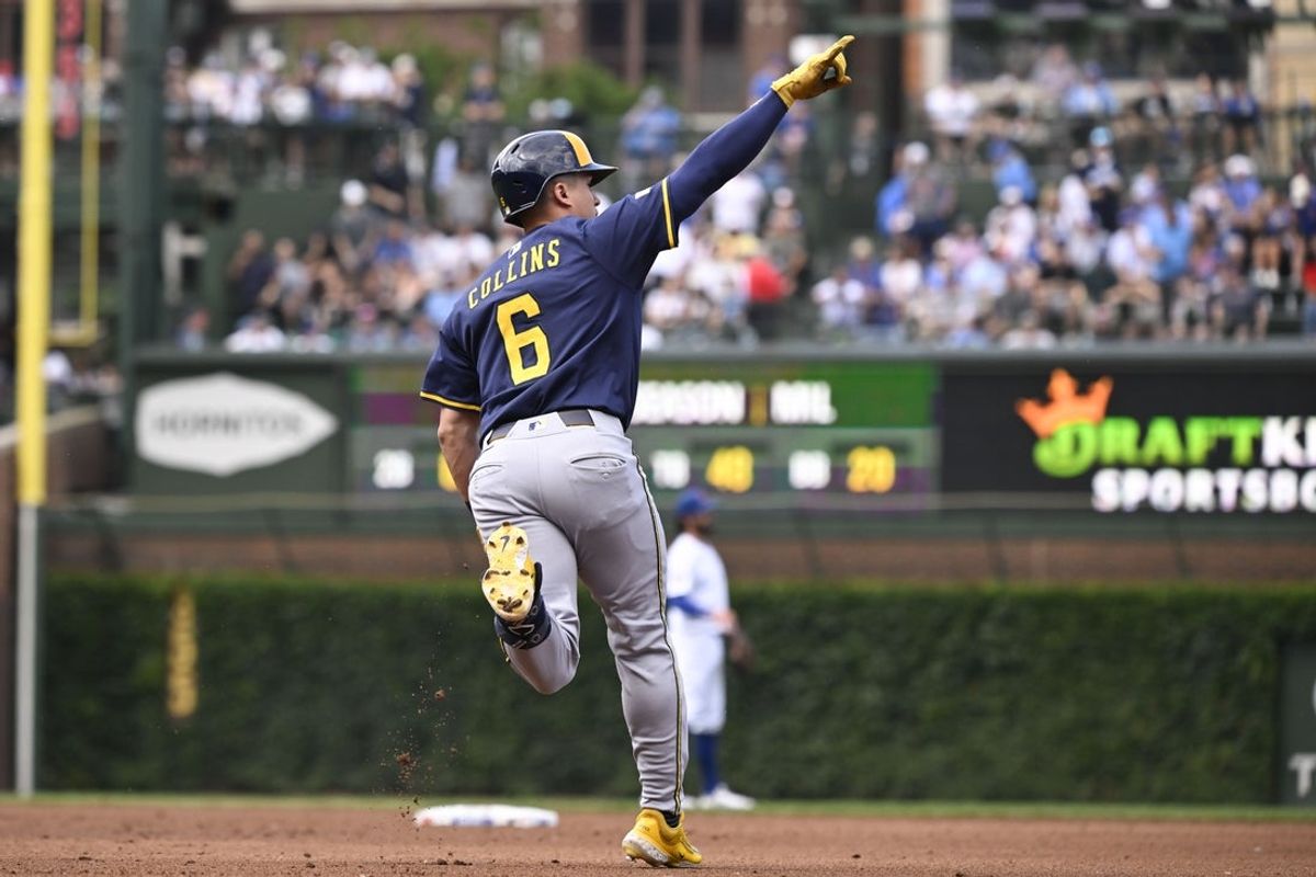 Jun 19, 2025; Chicago, Illinois, USA;  Milwaukee Brewers outfielder Isaac Collins (6) points after he hits a two run home run against the Chicago Cubs during the fifth inning at Wrigley Field. Mandatory Credit: Matt Marton-Imagn Images