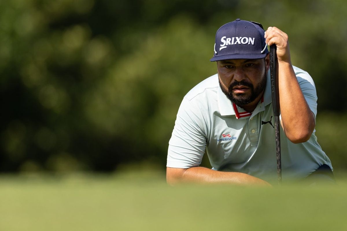 Jun 19, 2025; Cromwell, Connecticut, USA; J.J. Spaun lines up a putt on the 12th hole during the first round of the Travelers Championship golf tournament. Mandatory Credit: Bill Streicher-Imagn Images