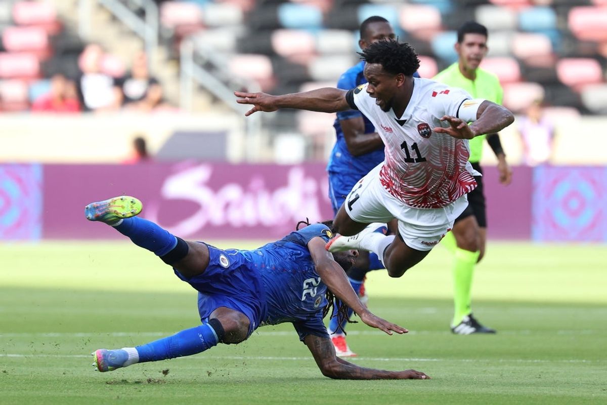 Jun 19, 2025; Houston, Texas, USA; Trinidad and Tobago midfielder Levi Garcia (11) and Haiti defender Jean-Kevin Duverne (22) collide in the first half during a group stage match of the 2025 Gold Cup at Shell Energy Stadium. Mandatory Credit: Troy Taormina-Imagn Images