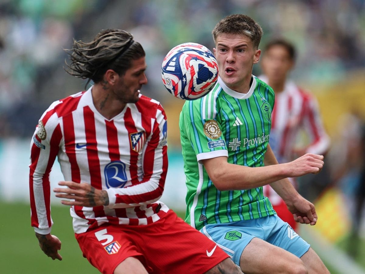 Jun 19, 2025; Seattle, Washington, USA; Atletico Madrid's Rodrigo De Paul in action with Seattle Sounders FC's Reed Baker-Whiting during a group stage match of the 2025 FIFA Club World Cup at Lumen Field. Mandatory Credit: Agustin Marcarian-Reuters via Imagn Images