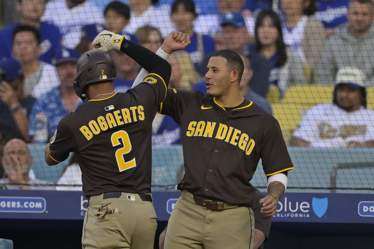 Jun 19, 2025; Los Angeles, California, USA;  San Diego Padres shortstop Xander Bogaerts (2) celebrates a solo home run with third base Manny Machado (13) during the second inning against the Los Angeles Dodgers at Dodger Stadium. Mandatory Credit: Jayne Kamin-Oncea-Imagn Images