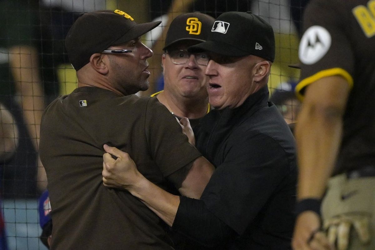 Jun 19, 2025; Los Angeles, California, USA;   San Diego Padres bench coach Brian Esposito (82) is held back by umpire Ryan Blakney (36) as manager Mike Shildt (8) looks on after benches cleared in the eighth inning against the Los Angeles Dodgers at Dodger Stadium. Mandatory Credit: Jayne Kamin-Oncea-Imagn Images