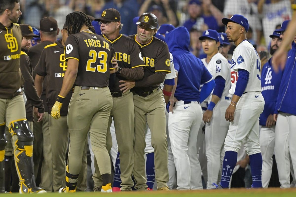 Jun 19, 2025; Los Angeles, California, USA;   San Diego Padres manager Mike Shildt (8) and third base coach Tim Leiper (33) with San Diego Padres right fielder Fernando Tatis Jr. (23) as Los Angeles Dodgers shortstop Mookie Betts (50) looks on after benches cleared in the eighth inning at Dodger Stadium. Mandatory Credit: Jayne Kamin-Oncea-Imagn Images