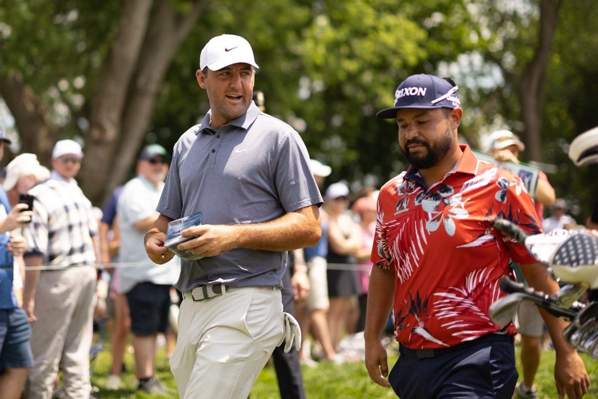 Jun 20, 2025; Cromwell, Connecticut, USA; Scottie Scheffler talks with J.J. Spaun as they walk to the on the eighth hole during the second round of the Travelers Championship golf tournament. Mandatory Credit: Bill Streicher-Imagn Images