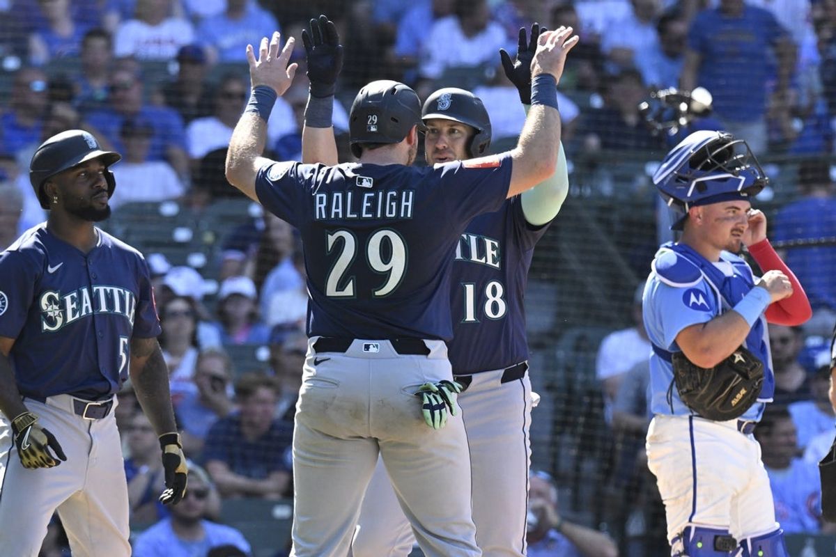 Jun 20, 2025; Chicago, Illinois, USA;  Seattle Mariners designated hitter Mitch Garver (18) celebrates his  three run home run against the Chicago Cubs with  catcher Cal Raleigh (29) during the ninth inning at Wrigley Field. Mandatory Credit: Matt Marton-Imagn Images