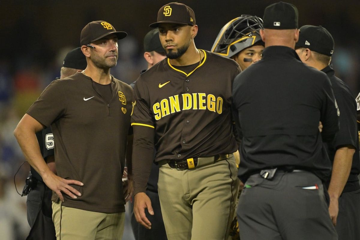 Jun 19, 2025; Los Angeles, California, USA;  San Diego Padres bench coach Brian Esposito (82) looks on as elief pitcher Robert Suarez (75) is ejected from the game after hitting Los Angeles Dodgers designated hitter Shohei Ohtani (17) with a pitch in the ninth inning at Dodger Stadium. Mandatory Credit: Jayne Kamin-Oncea-Imagn Images