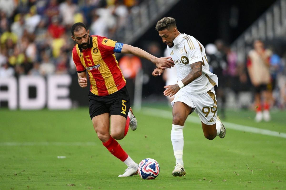 Jun 20, 2025; Nashville, Tennessee, USA; LAFC forward Denis Bouanga (99) and Esperance Sportive De Tunisie defender Yassine Meriah (5) battle for the ball in the second half during a group stage match of the 2025 FIFA Club World Cup at GEODIS Park. Mandatory Credit: Steve Roberts-Imagn Images