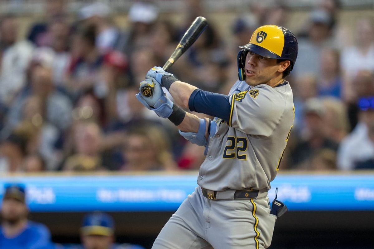 Jun 20, 2025; Minneapolis, Minnesota, USA; Milwaukee Brewers designated hitter Christian Yelich (22) hits a RBI single against the Minnesota Twins in the sixth inning at Target Field. Mandatory Credit: Jesse Johnson-Imagn Images