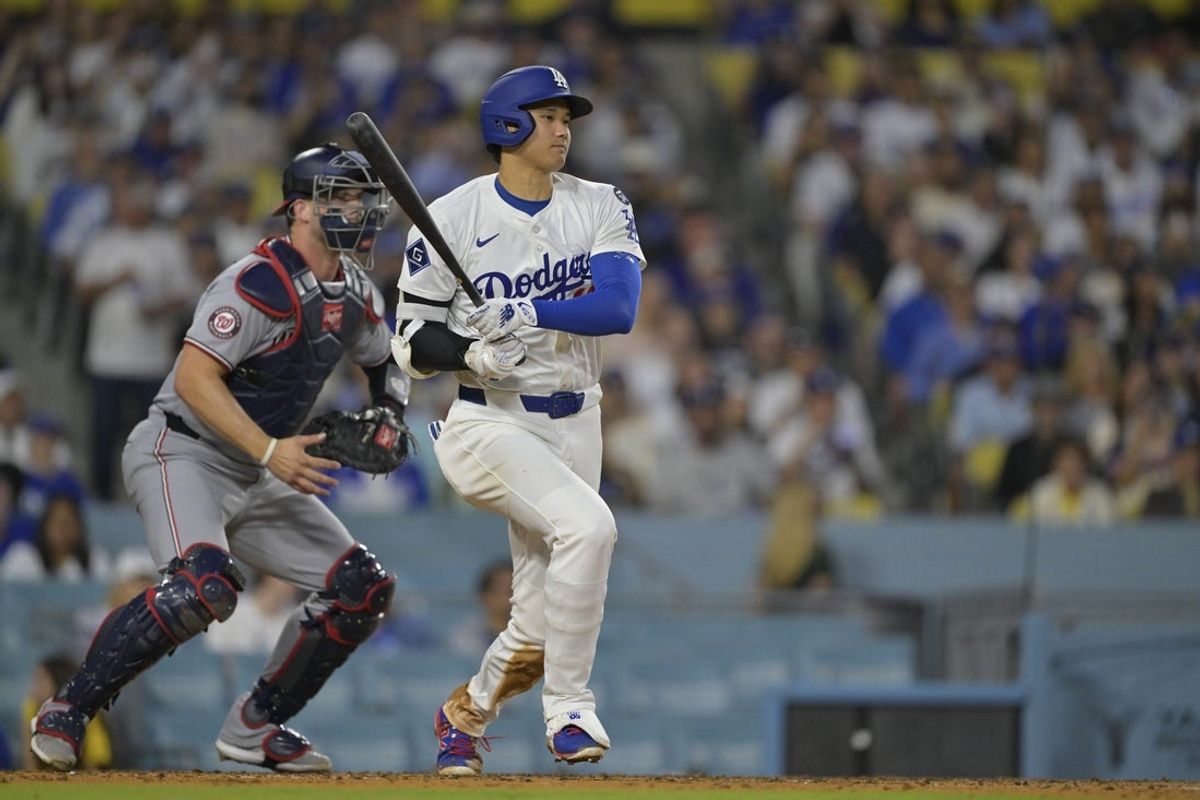 Jun 20, 2025; Los Angeles, California, USA;  Los Angeles Dodgers two-way player Shohei Ohtani (17) hits a RBI single during the fourth inning against the Washington Nationals at Dodger Stadium. Mandatory Credit: Jayne Kamin-Oncea-Imagn Images