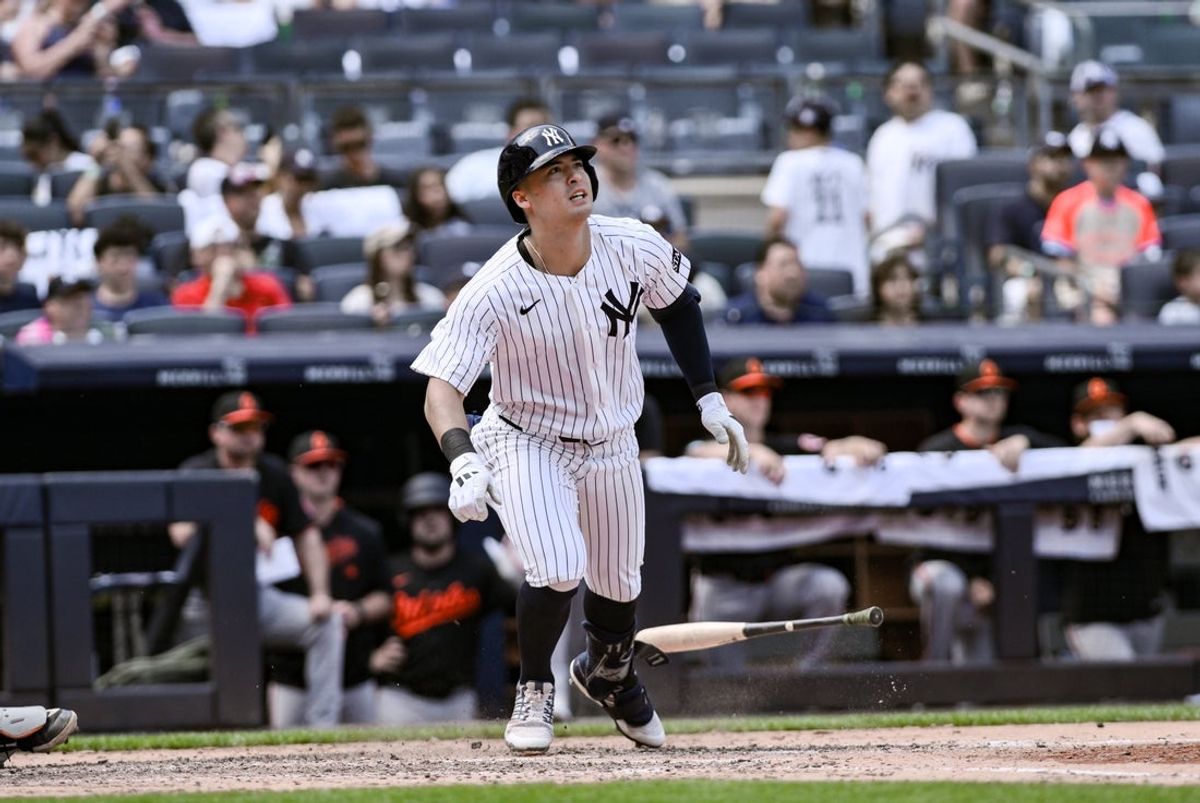 Jun 21, 2025; Bronx, New York, USA; New York Yankees shortstop Anthony Volpe (11) hits a solo home run against the Baltimore Orioles during the fifth inning at Yankee Stadium. Mandatory Credit: John Jones-Imagn Images