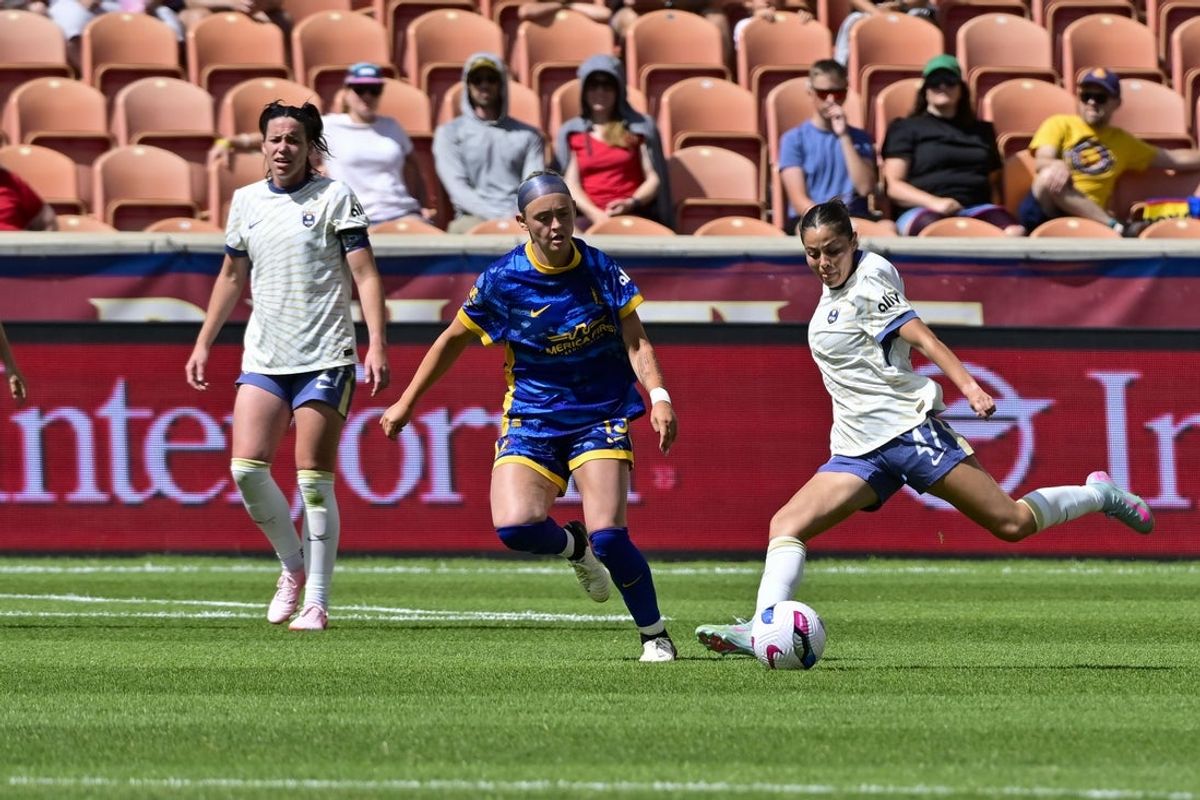 Jun 21, 2025; Sandy, Utah, USA; Seattle Reign FC forward Emeri Adames (47) makes a cross pass against Utah Royals forward Brecken Mozingo (13) during the second half at America First Field. Mandatory Credit: Peter Creveling-Imagn Images