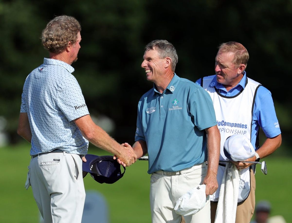 Steven Alker of New Zealand, right, shakes hands with Tim Petrovic of Austin, Texas after finishing tied for first during the third round of the 2025 Kaulig Companies Championship at Firestone Country Club, Saturday, June 21, 2025, in Akron, Ohio.