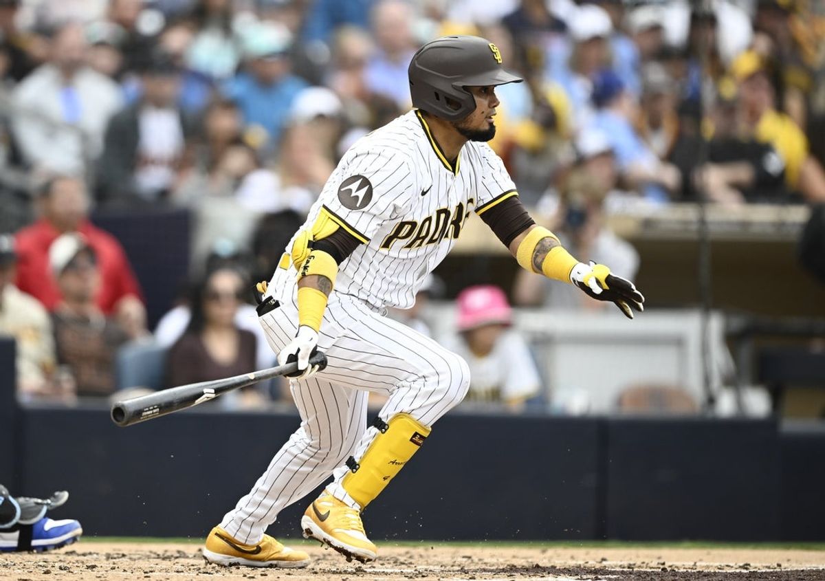Jun 21, 2025; San Diego, California, USA; San Diego Padres first baseman Luis Arraez (4) hits an RBI single during the third inning against the Kansas City Royals at Petco Park. Mandatory Credit: Denis Poroy-Imagn Images