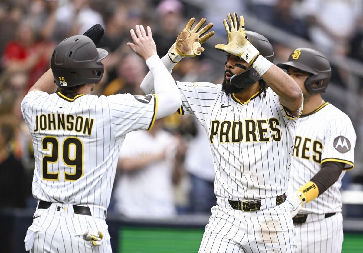 Jun 21, 2025; San Diego, California, USA; San Diego Padres right fielder Fernando Tatis Jr. (23) is congratulated by Bryce Johnson (29) after hitting a three-run home run during the seventh inning against the Kansas City Royals at Petco Park. Mandatory Credit: Denis Poroy-Imagn Images