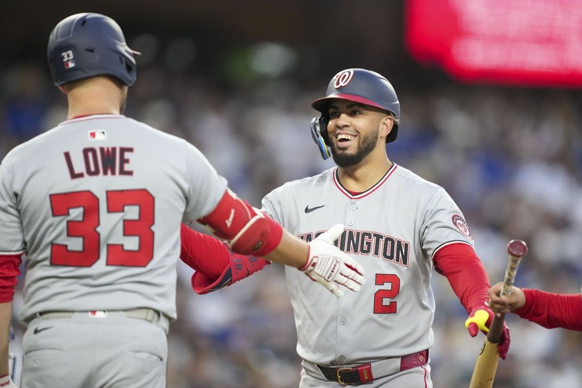 Jun 21, 2025; Los Angeles, California, USA; Washington Nationals second base Luis García Jr. (2) celebrates with first base Nathaniel Lowe (33) after scoring a home run in the fourth inning against the Los Angeles Dodgers at Dodger Stadium. Mandatory Credit: Kirby Lee-Imagn Images