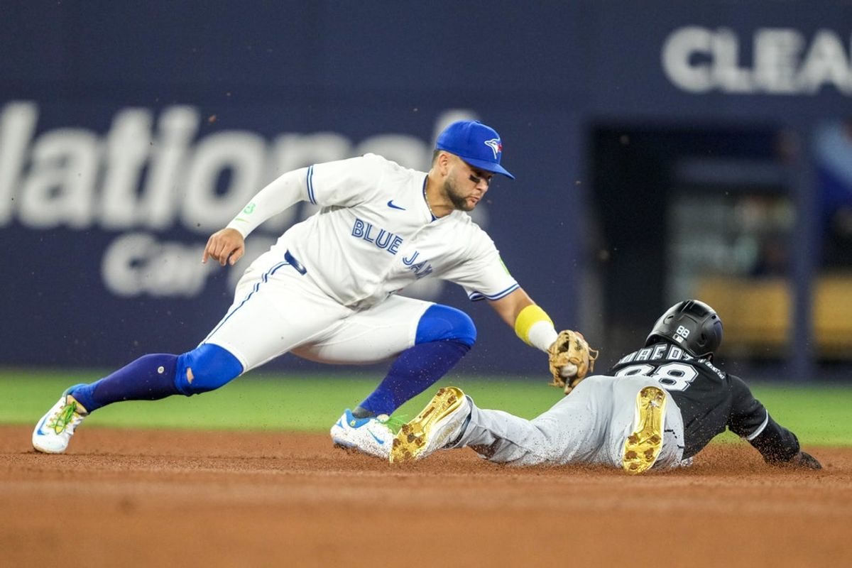 Jun 22, 2025; Toronto, Ontario, CAN; Chicago White Sox outfielder Luis Robert Jr. (88) caught stealing by Toronto Blue Jays shortstop Bo Bichette (11) during the fourth inning in their MLB game at Rogers Centre. Mandatory Credit: Kevin Sousa-Imagn Images