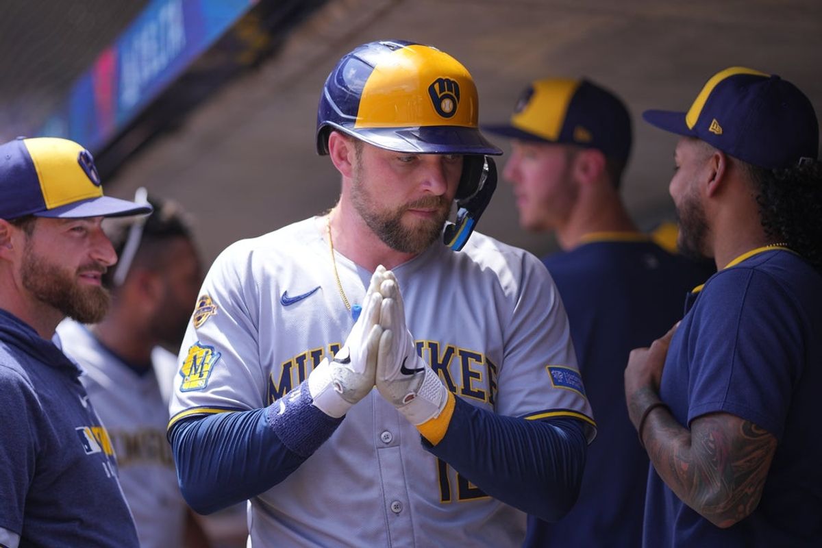 Jun 22, 2025; Minneapolis, Minnesota, USA; Milwaukee Brewers first base Rhys Hoskins (12) celebrates his run against the Minnesota Twins in the second inning at Target Field. Mandatory Credit: Brad Rempel-Imagn Images
