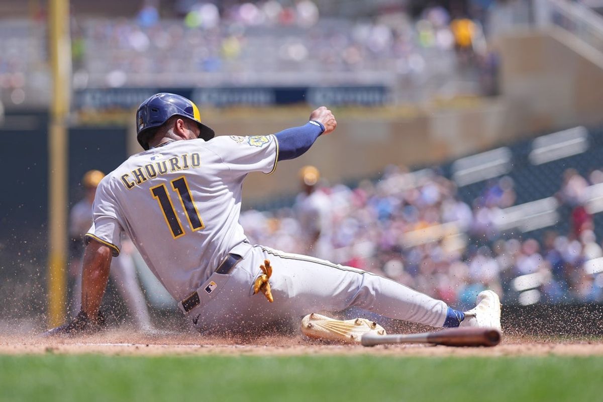 Jun 22, 2025; Minneapolis, Minnesota, USA; Milwaukee Brewers outfielder Jackson Chourio (11) slides home against the Minnesota Twins in the third inning at Target Field. Mandatory Credit: Brad Rempel-Imagn Images
