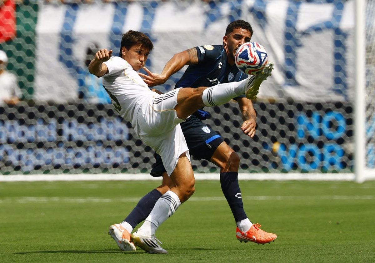 [Subscription Customers Only] Jun 22, 2025; Charlotte, North Carolina, USA; Real Madrid defender Gonzalo Garcia  (20) in action with Pachuca defender Federico Pereira (16) during a group stage match of the 2025 FIFA Club World Cup at Bank of America Stadium. Mandatory Credit: Susana Vera-Reuters via Imagn Images