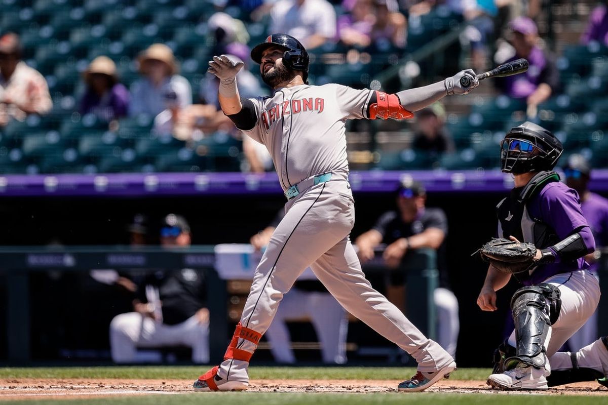 Jun 22, 2025; Denver, Colorado, USA; Arizona Diamondbacks third baseman Eugenio Suarez (28) watches his ball on a double in the second inning against the Colorado Rockies at Coors Field. Mandatory Credit: Isaiah J. Downing-Imagn Images