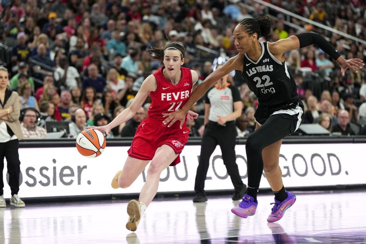 Jun 22, 2025; Las Vegas, Nevada, USA; Indiana Fever guard Caitlin Clark (22) dribbles the ball against Las Vegas Aces center A'ja Wilson (22) during the second half of a WNBA basketball game at T-Mobile Arena. Mandatory Credit: Lucas Peltier-Imagn Images