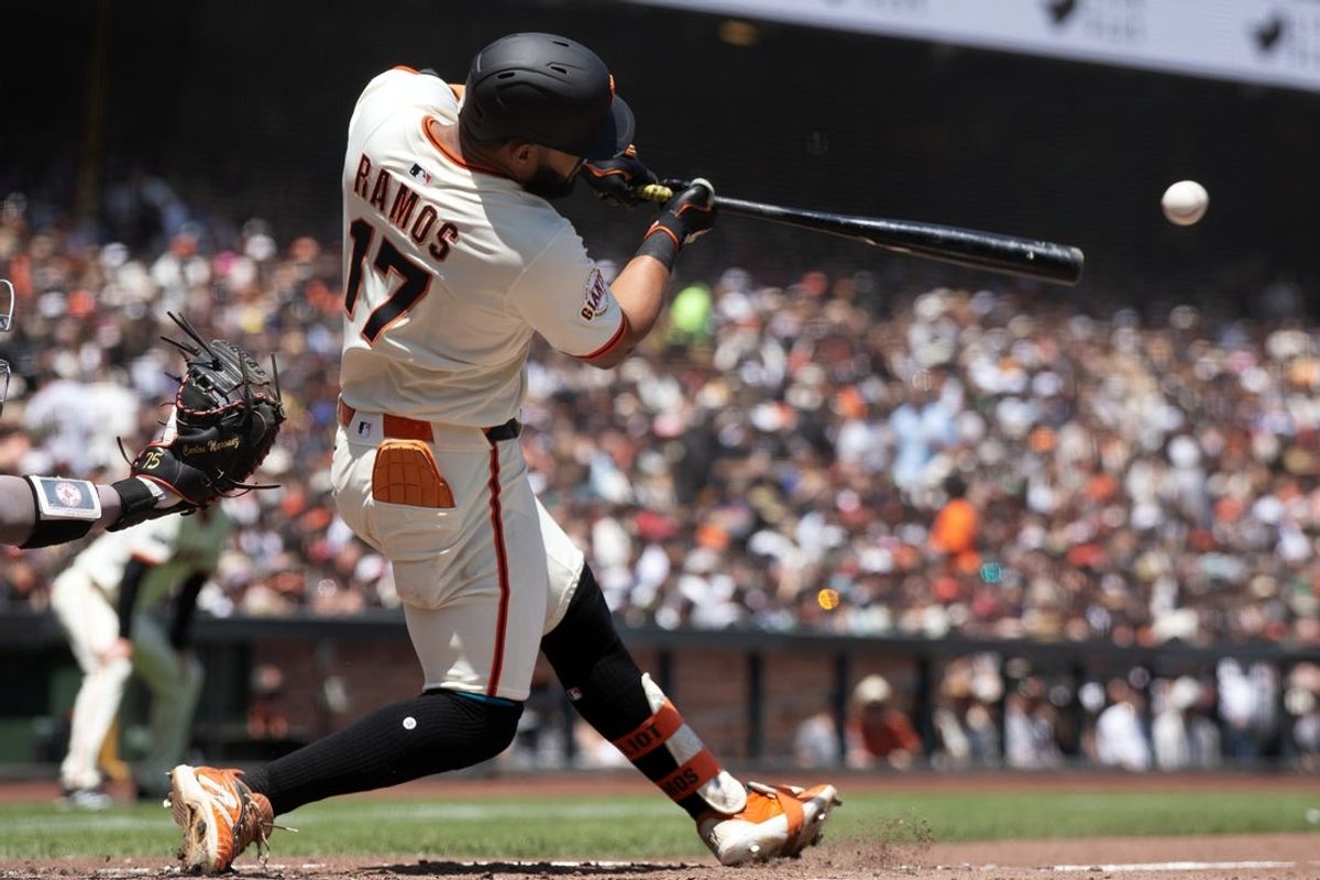 Jun 22, 2025; San Francisco, California, USA; San Francisco Giants left fielder Heliot Ramos (17) connects to a two-RBI double against the Boston Red Sox during the third inning at Oracle Park. Mandatory Credit: D. Ross Cameron-Imagn Images