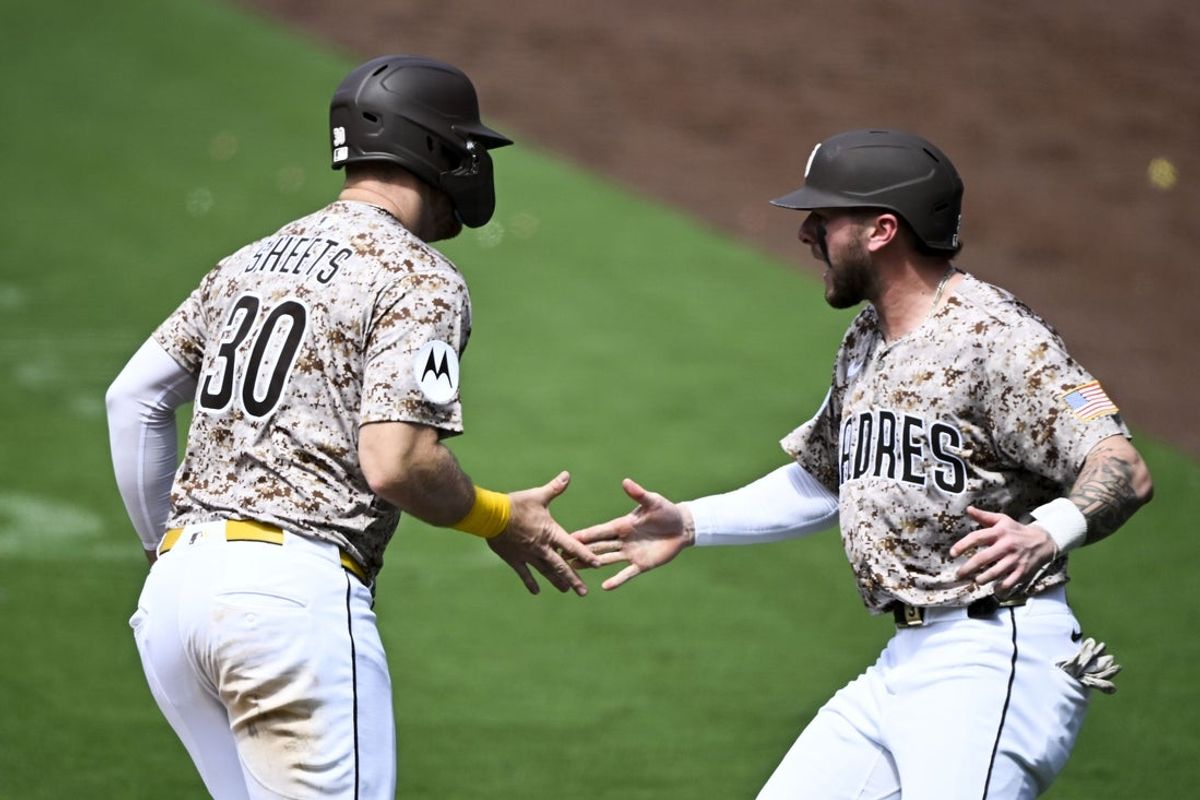 Jun 22, 2025; San Diego, California, USA; San Diego Padres first base Gavin Sheets (30) is congratulated by Jackson Merrill (3) after scoring during the seventh inning against the Kansas City Royals at Petco Park. Mandatory Credit: Denis Poroy-Imagn Images
