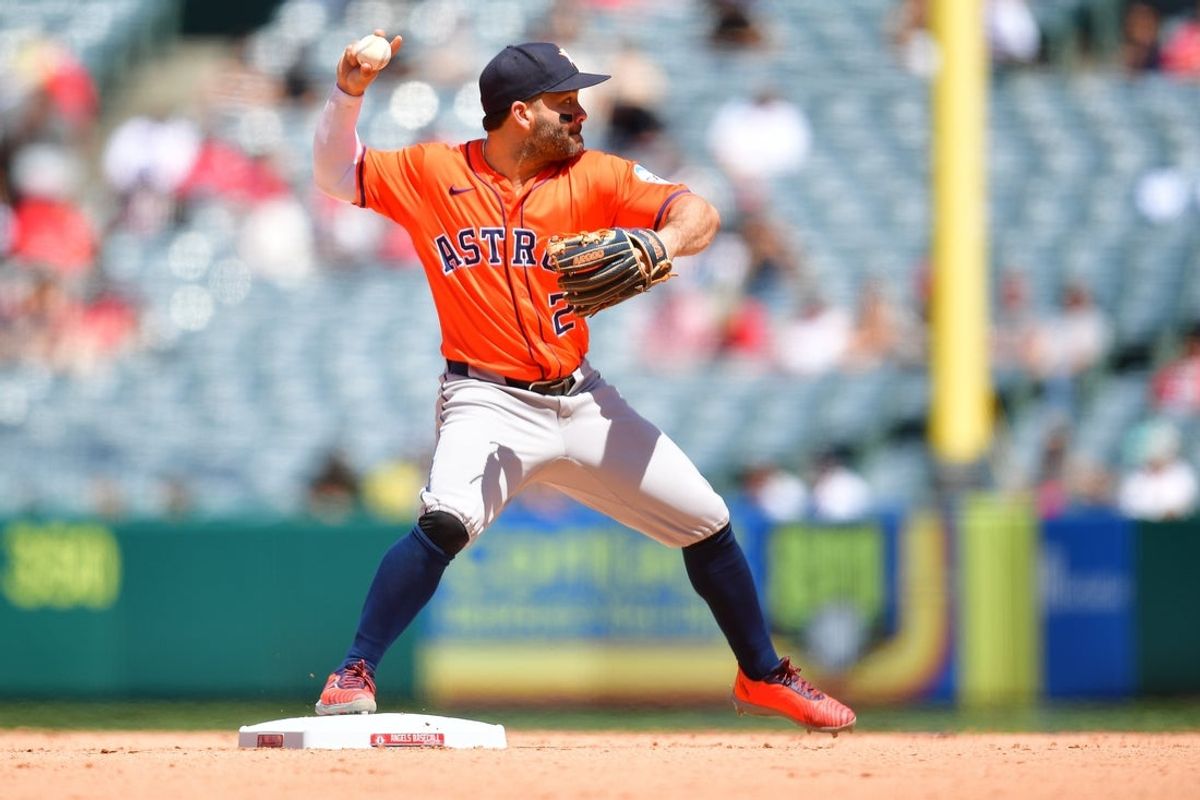 Jun 22, 2025; Anaheim, California, USA; Houston Astros left fielder Jose Altuve (27) throws against the Los Angeles Angels during the seventh inning at Angel Stadium. Mandatory Credit: Gary A. Vasquez-Imagn Images