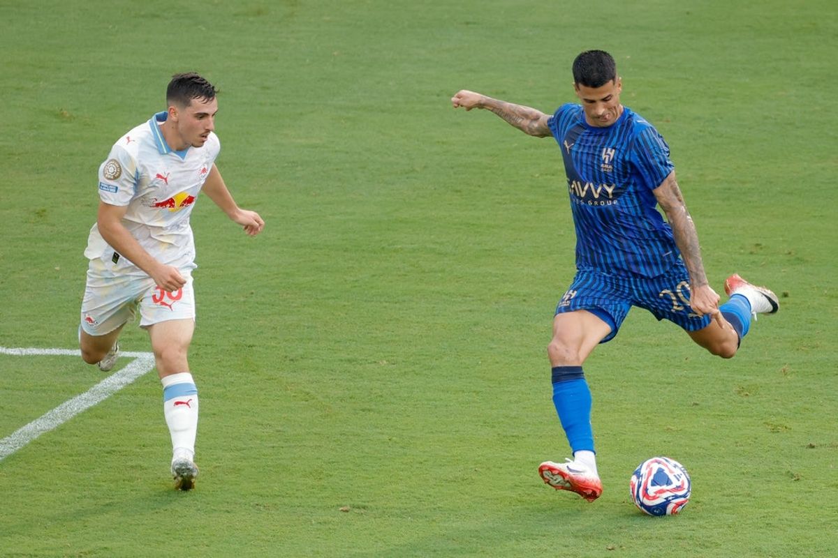 Jun 22, 2025; Washington, District of Columbia, USA; Al Hilal FC defender Joao Cancelo (20) kicks the ball defended by FC Salzburg midfielder Oscar Gloukh (30) in the first half during a group stage match of the 2025 FIFA Club World Cup at Audi Field. Mandatory Credit: Amber Searls-Imagn Images