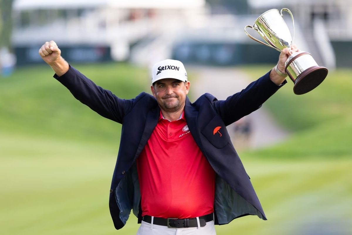 Jun 22, 2025; Cromwell, Connecticut, USA; Keegan Bradley raises the Travelers Championship trophy after winning the Travelers Championship golf tournament. Mandatory Credit: Bill Streicher-Imagn Images