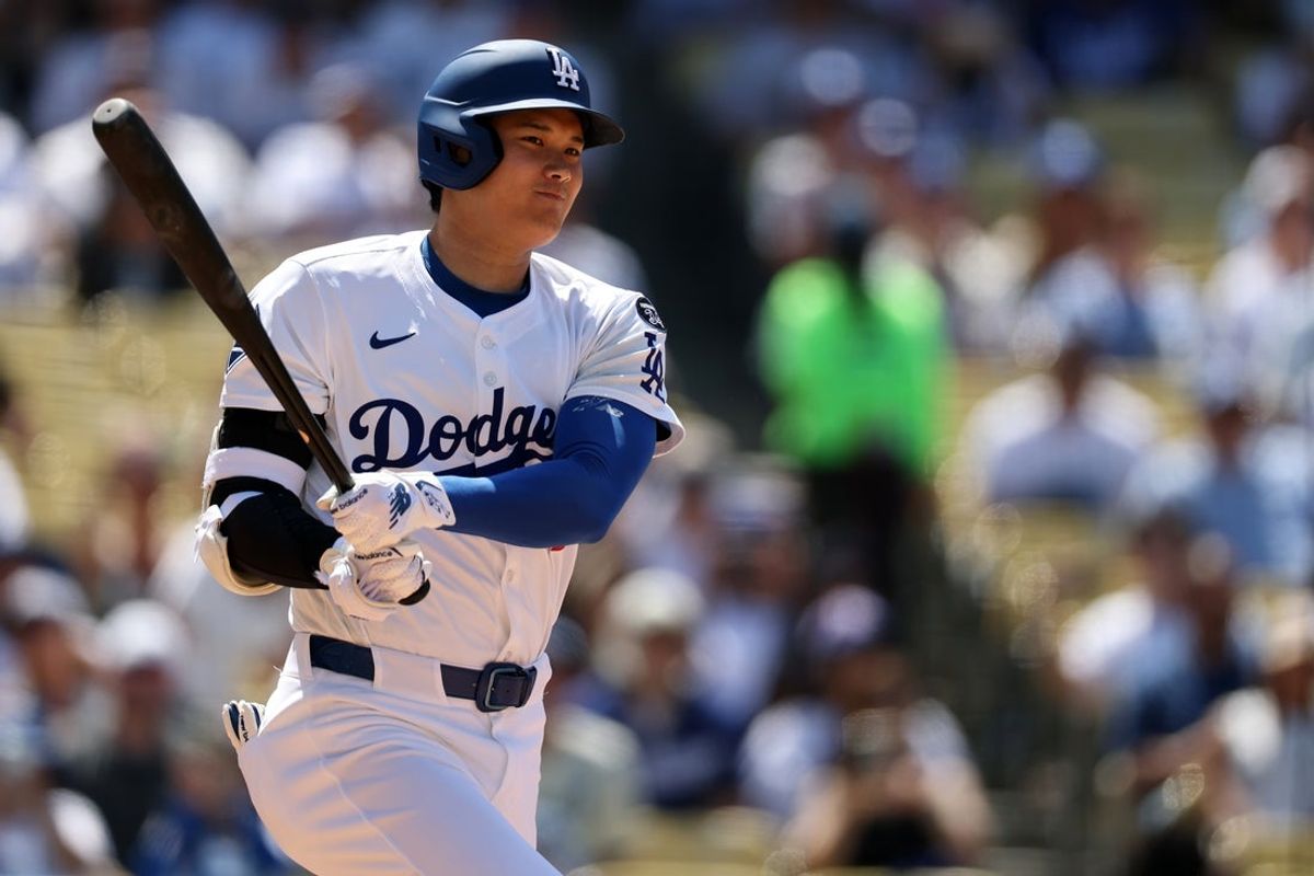 Jun 22, 2025; Los Angeles, California, USA;  Los Angeles Dodgers two-way player Shohei Ohtani (17) hits a triple during the seventh inning against the Washington Nationals at Dodger Stadium. Mandatory Credit: Kiyoshi Mio-Imagn Images